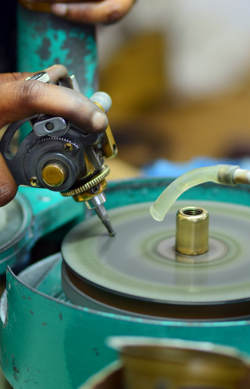 A Jayamini Gems craftsperson polishing a gemstone